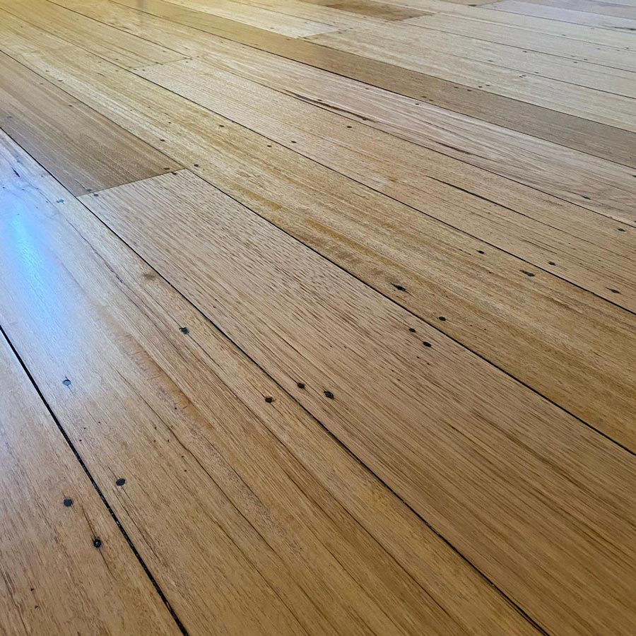 Old Recycled Hardwood, with a rustic look by filling the nail holes with black Putty. Finished in a Satin Polyurethane.